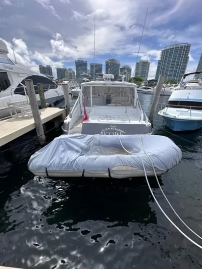 Kore Yacht Photos Pics 2006 Baia 63 Azzurra yacht docked at marina with inflatable boat.