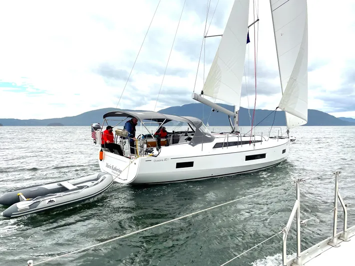 Marie Katherine Yacht Photos Pics 2022 Beneteau Oceanis 40.1 sailing on open water with inflatable dinghy attached.