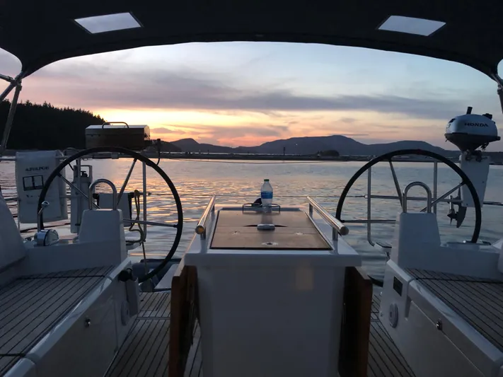 Marie Katherine Yacht Photos Pics Beneteau Oceanis 40.1 sailboat cockpit at sunset, 2022 model, serene water view.