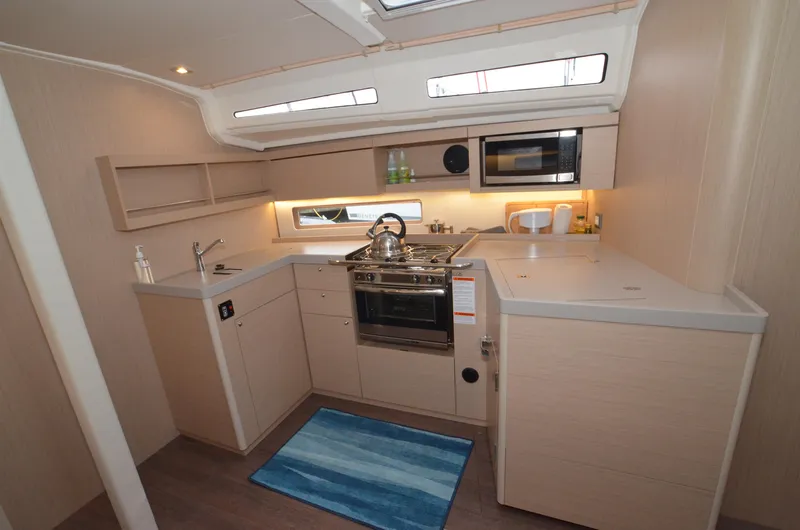 Marie Katherine Yacht Photos Pics Modern kitchen interior of 2022 Beneteau Oceanis 40.1 yacht with sleek cabinetry and appliances.