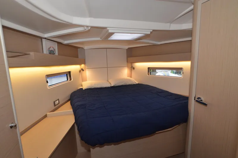 Marie Katherine Yacht Photos Pics Luxurious cabin interior of 2022 Beneteau Oceanis 40.1 yacht with cozy bed and ambient lighting.