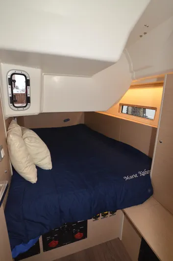 Marie Katherine Yacht Photos Pics Cozy cabin interior of 2022 Beneteau Oceanis 40.1 yacht with bed and porthole.