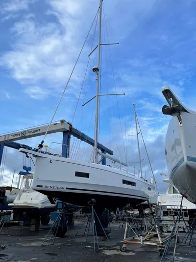 Marie Katherine Yacht Photos Pics 2022 Beneteau Oceanis 40.1 sailboat in a shipyard under a blue sky.