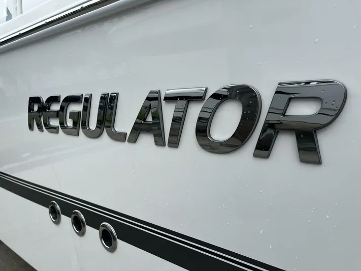  Yacht Photos Pics Regulator 30XO 2025 boat logo on sleek white hull.