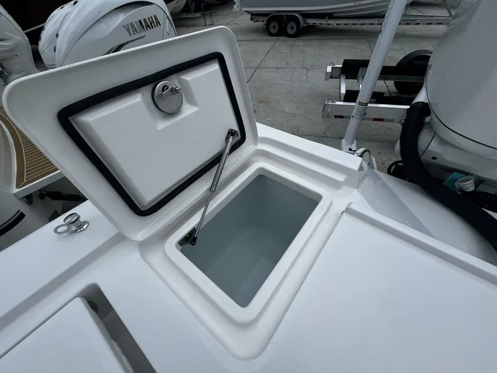  Yacht Photos Pics 2025 Regulator 30XO boat storage compartment with open lid, showcasing interior space.
