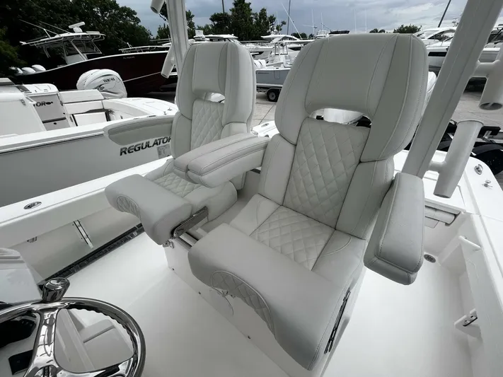  Yacht Photos Pics 2025 Regulator 30XO boat with luxurious white leather seating and sleek design.