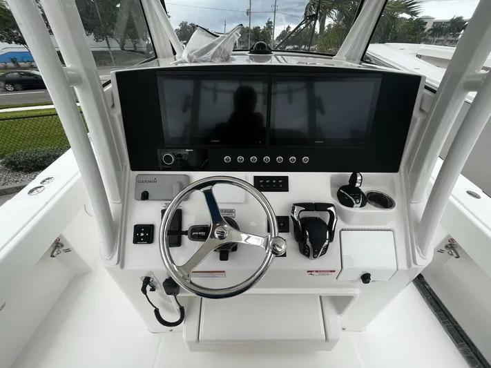  Yacht Photos Pics 2025 Regulator 30XO boat helm with dual Garmin displays and steering wheel.