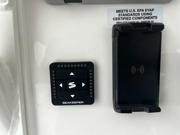 Yacht Photos Pics Control panel and wireless charger on 2025 Regulator 30XO boat, meeting EPA standards.