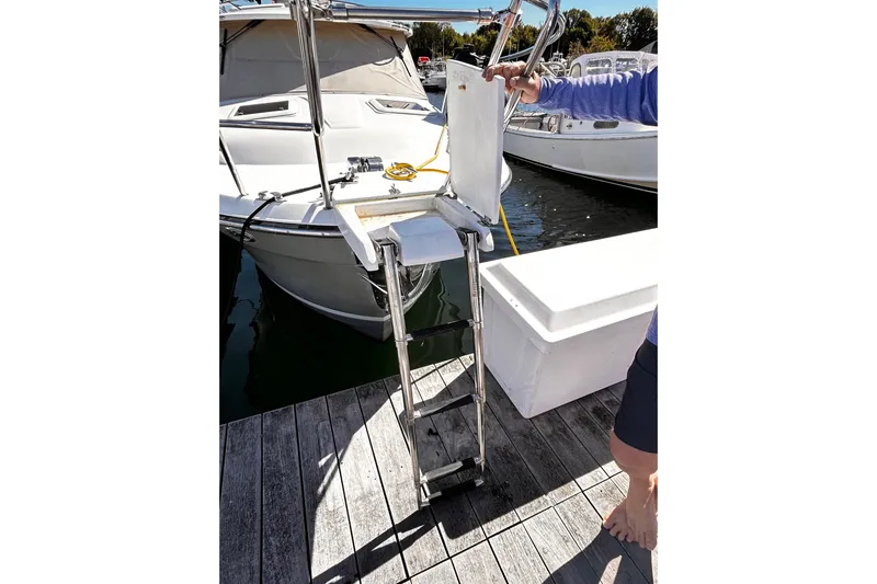  Yacht Photos Pics 2014 Cutwater C-28 boat with boarding ladder on dock.