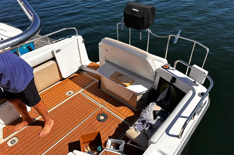  Yacht Photos Pics 2014 Cutwater C-28 boat deck with wooden flooring and seating area.