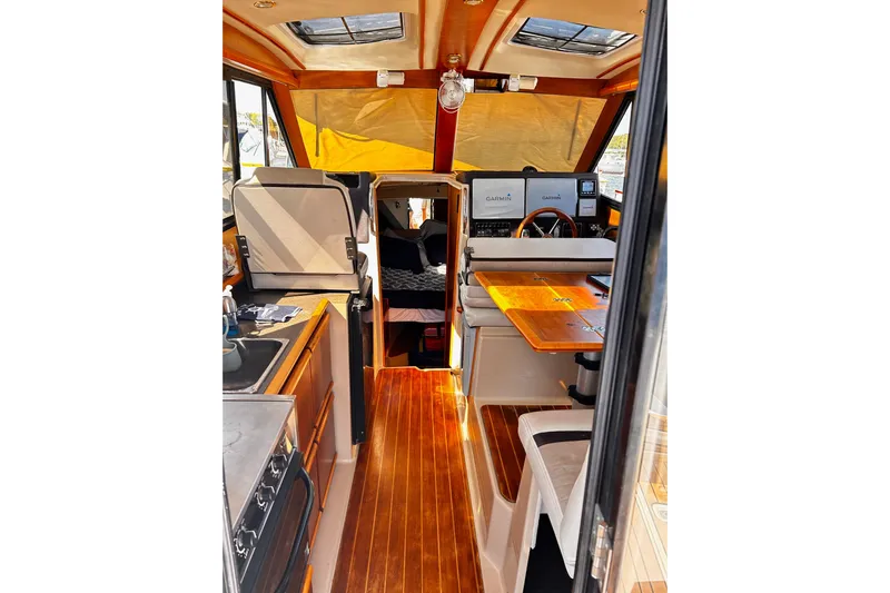  Yacht Photos Pics Interior of 2014 Cutwater C-28 boat with wood flooring and navigation equipment.