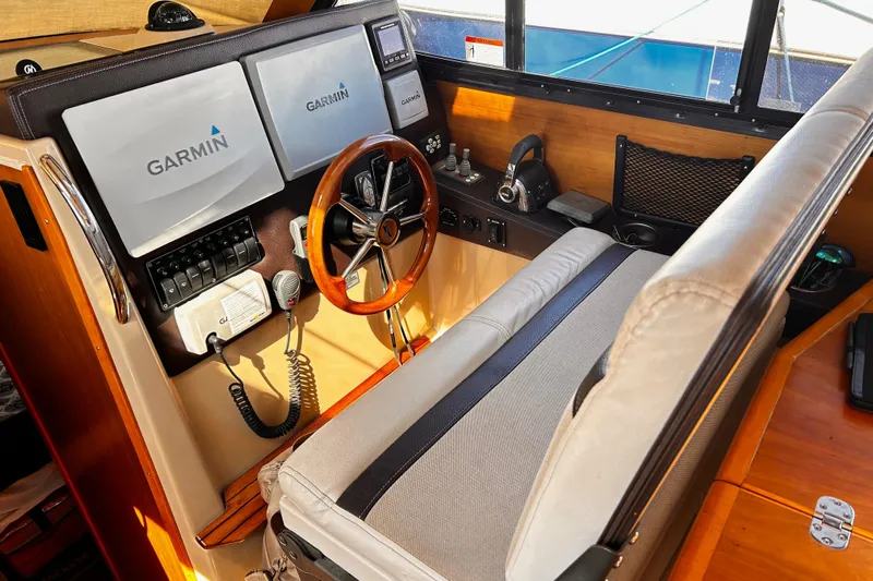  Yacht Photos Pics 2014 Cutwater C-28 helm with Garmin navigation, wood accents, and comfortable seating.