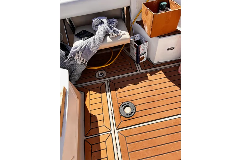  Yacht Photos Pics 2014 Cutwater C-28 boat deck with wooden flooring, seat, and storage items.