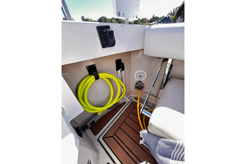  Yacht Photos Pics 2014 Cutwater C-28 boat interior with coiled yellow hose and teak flooring.