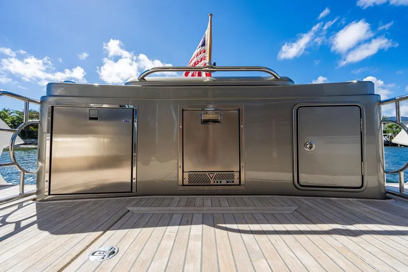 El Mar V Yacht Photos Pics Riviera 6000SY 2022 yacht deck with storage compartments and American flag.
