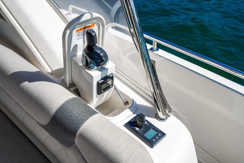 El Mar V Yacht Photos Pics Riviera 6000SY 2022 yacht control panel with joystick and display, overlooking water.