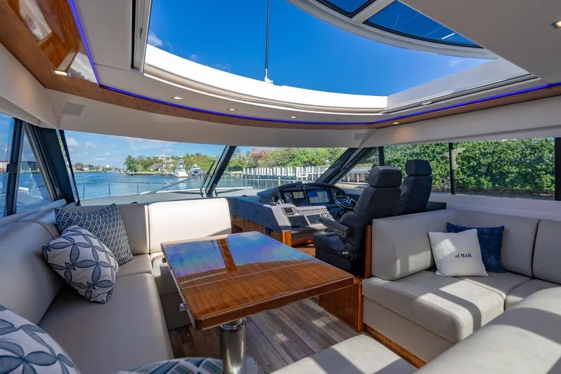 El Mar V Yacht Photos Pics Luxurious interior of 2022 Riviera 6000SY yacht with plush seating and panoramic views.