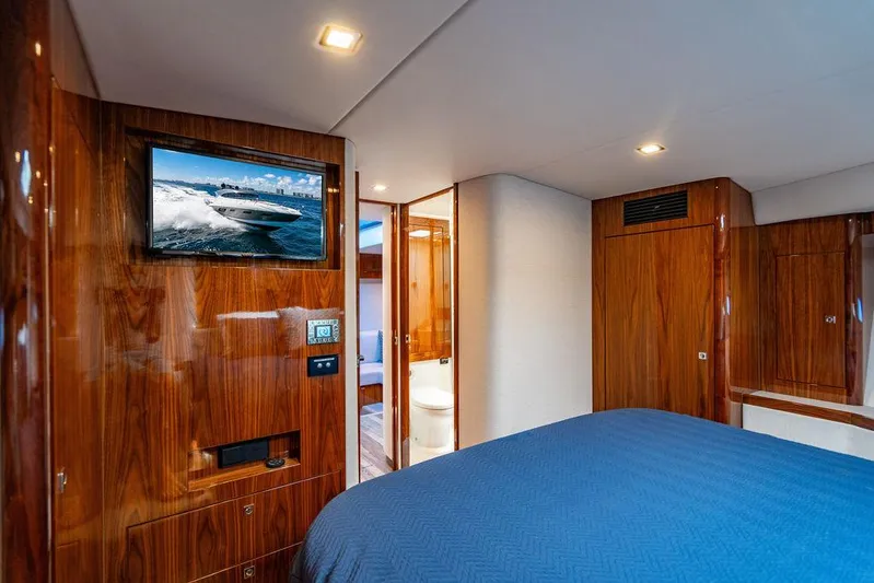 El Mar V Yacht Photos Pics Luxurious interior of 2022 Riviera 6000SY yacht with wood paneling and modern amenities.