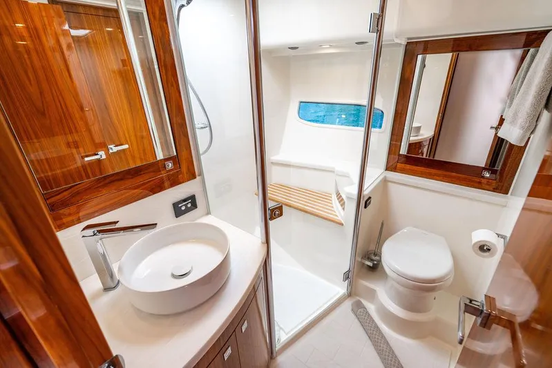 El Mar V Yacht Photos Pics Luxurious bathroom in 2022 Riviera 6000SY yacht, featuring modern fixtures and elegant wood accents.