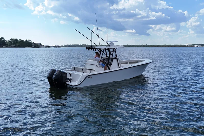  Yacht Photos Pics 2023 SeaVee 32 boat on calm water under a partly cloudy sky.