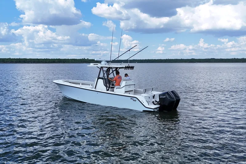  Yacht Photos Pics 2023 SeaVee 32 boat on calm water under a partly cloudy sky.