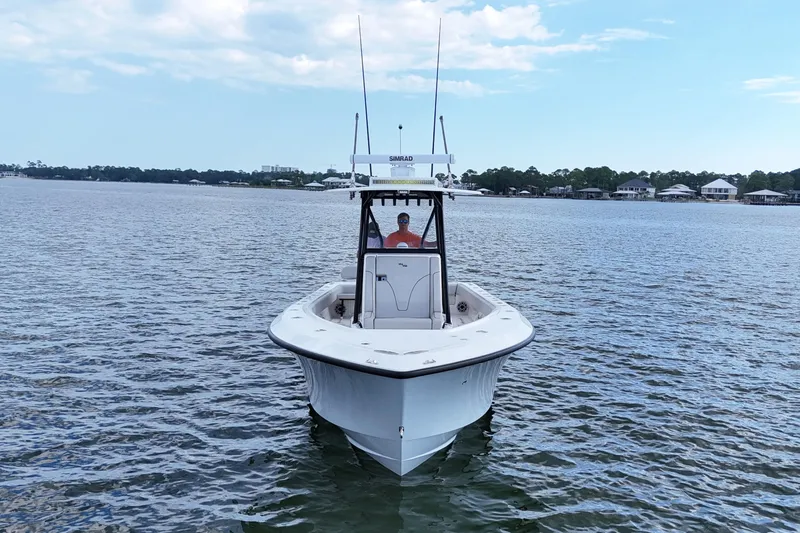  Yacht Photos Pics 2023 SeaVee 32 boat on calm water under a partly cloudy sky.