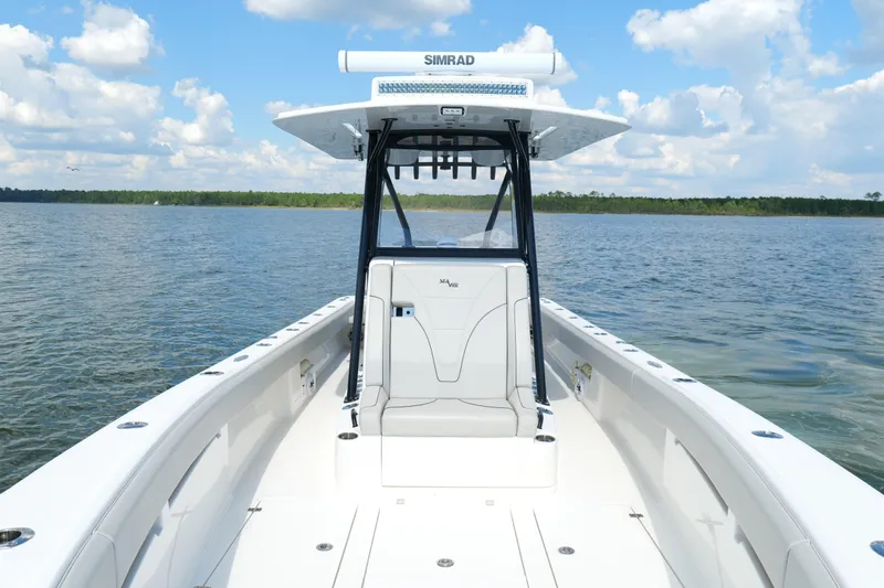  Yacht Photos Pics 2023 SeaVee 32 boat on calm water under a blue sky with clouds.