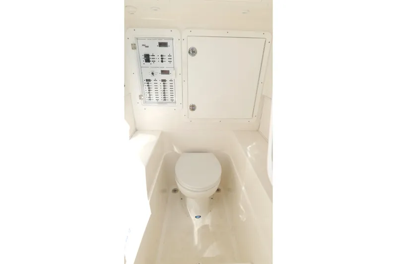  Yacht Photos Pics 2023 SeaVee 32 boat interior with toilet and control panel.