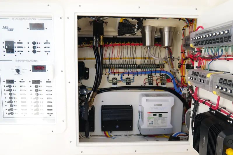  Yacht Photos Pics Electrical control panel of a 2023 SeaVee 32 boat, showcasing wiring and components.