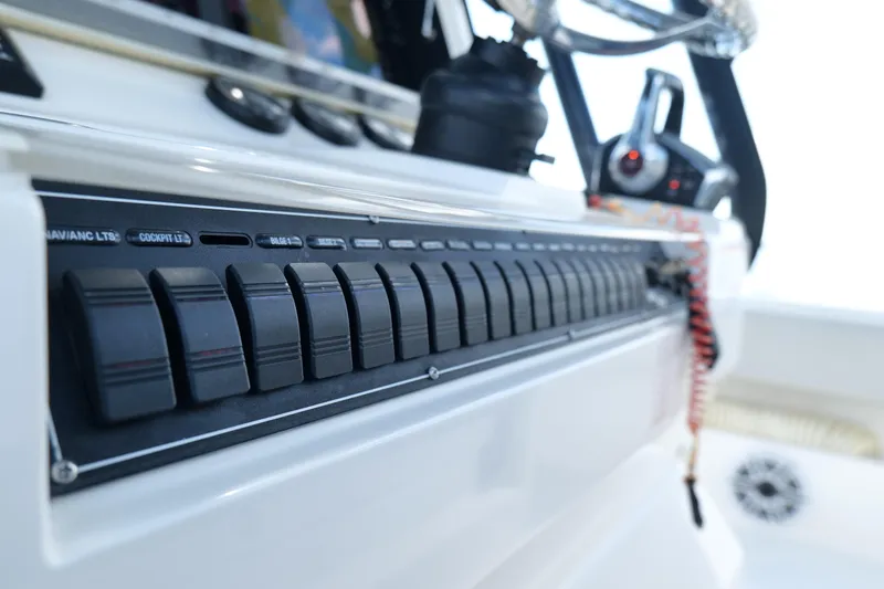  Yacht Photos Pics Control panel of 2023 SeaVee 32 boat, featuring switches and steering wheel.