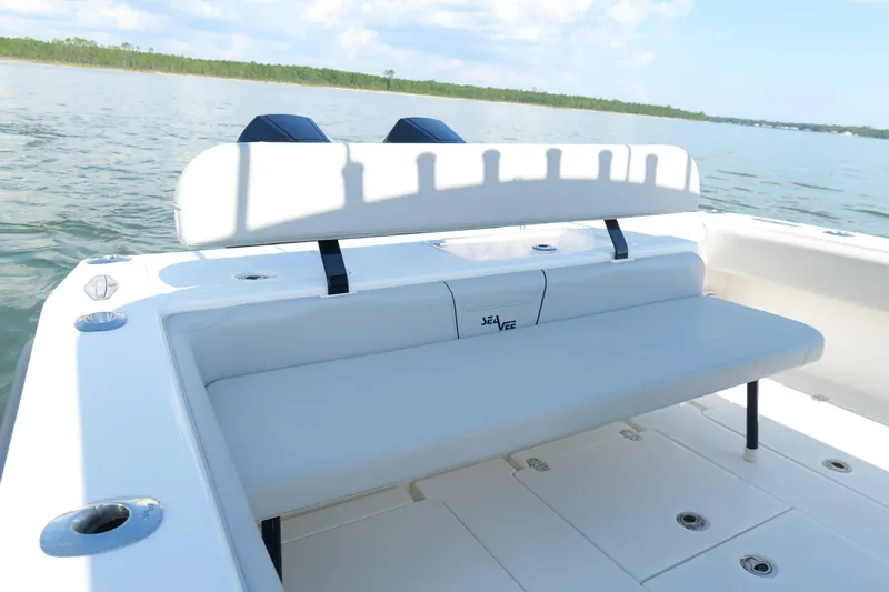  Yacht Photos Pics 2023 SeaVee 32 boat with white seating, on calm water.