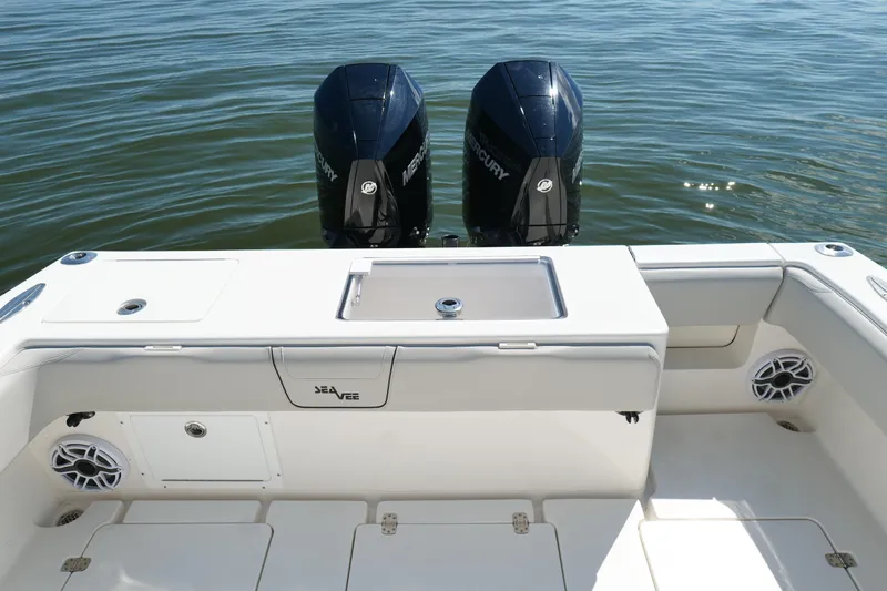  Yacht Photos Pics 2023 SeaVee 32 boat with dual Mercury engines on calm water.