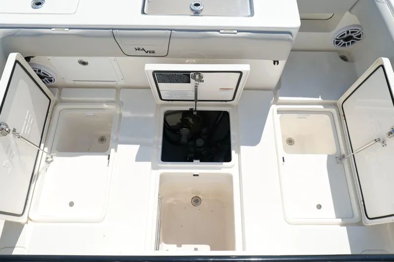  Yacht Photos Pics 2023 SeaVee 32 boat deck with open storage compartments and clean design.