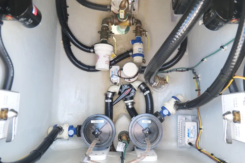  Yacht Photos Pics Engine compartment of 2023 SeaVee 32 boat, showcasing intricate wiring and plumbing systems.