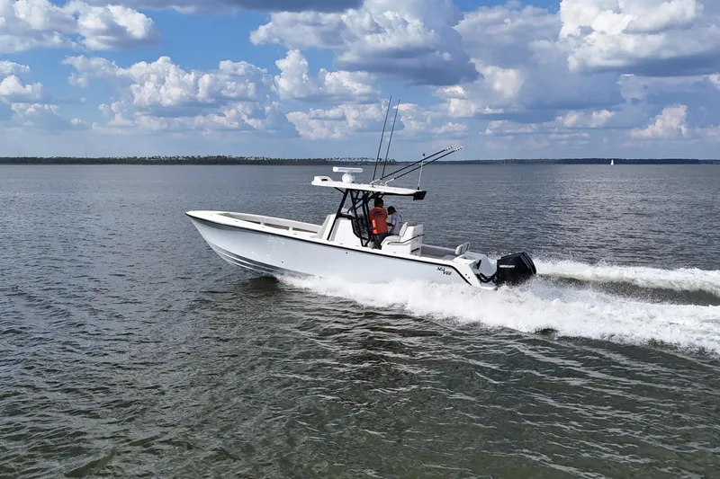  Yacht Photos Pics 2023 SeaVee 32 boat cruising on open water under a cloudy sky.
