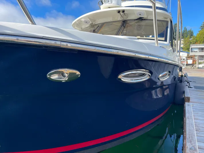  Yacht Photos Pics 2015 Cutwater 30 CB boat docked, featuring sleek blue hull and chrome accents.