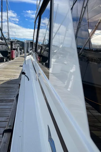  Yacht Photos Pics 2015 Cutwater 30 CB boat docked, showcasing sleek design and reflective windows.