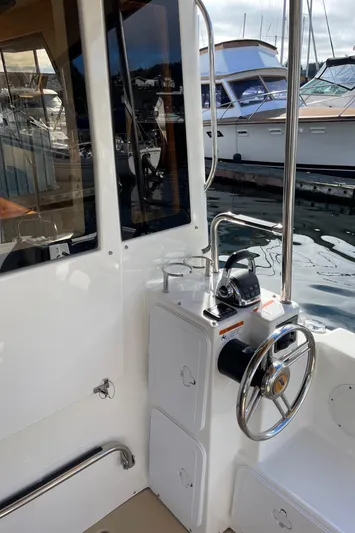  Yacht Photos Pics 2015 Cutwater 30 CB boat helm with steering wheel and controls, docked at marina.