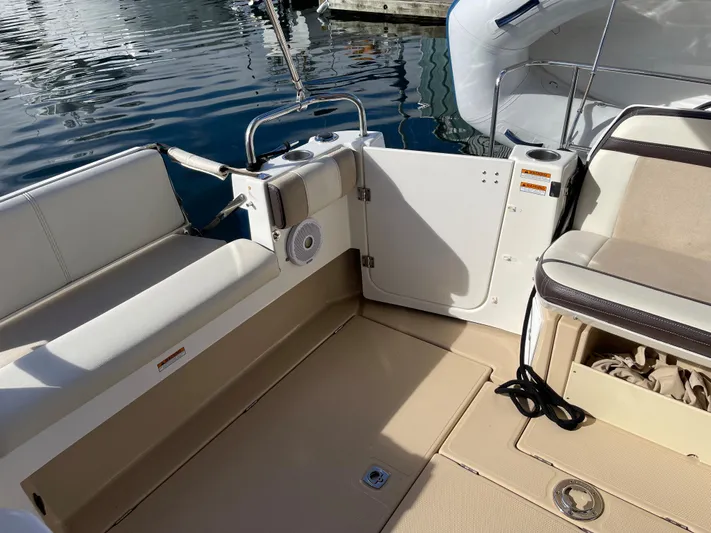  Yacht Photos Pics 2015 Cutwater 30 CB boat interior with seating and storage, docked by the water.