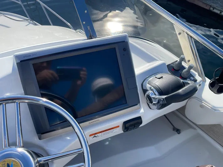  Yacht Photos Pics Close-up of 2015 Cutwater 30 CB boat dashboard with Garmin display and steering wheel.