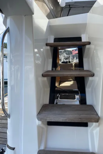  Yacht Photos Pics Stairs on a 2015 Cutwater 30 CB boat, featuring wooden steps and a sleek design.