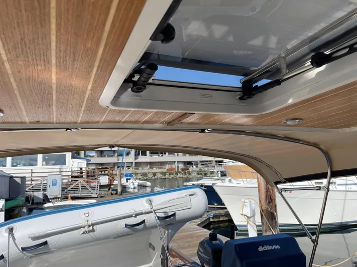  Yacht Photos Pics 2015 Cutwater 30 CB boat interior with open sunroof at marina.