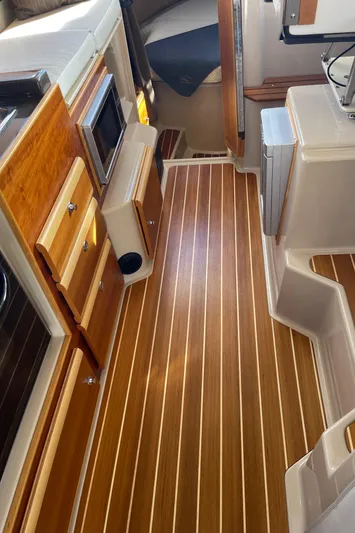  Yacht Photos Pics Interior of a 2015 Cutwater 30 CB boat with wood flooring and modern amenities.