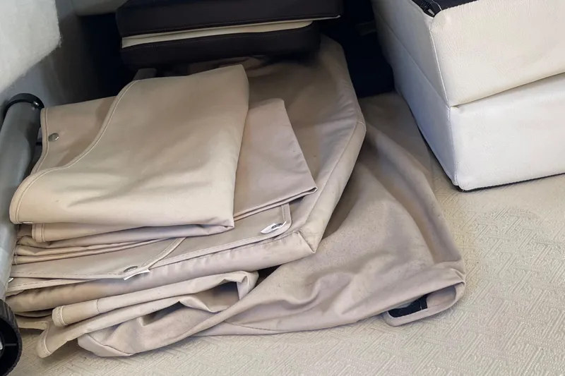  Yacht Photos Pics Folded beige covers inside a 2015 Cutwater 30 CB boat interior.