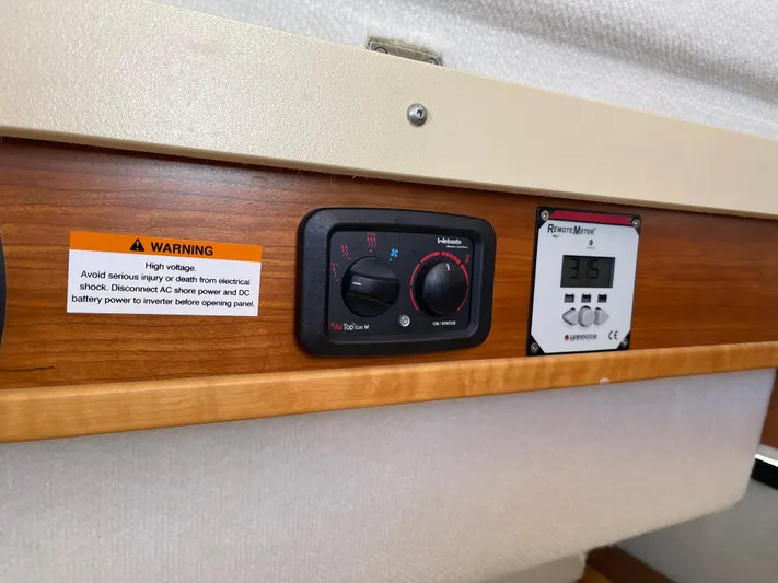  Yacht Photos Pics Control panel of a 2015 Cutwater 30 CB boat with warning label and digital display.