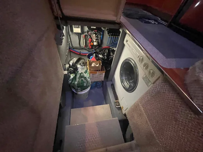 Andiamo II Yacht Photos Pics Laundry area in 2002 Sea Ray 480 Motor Yacht with washing machine and storage.