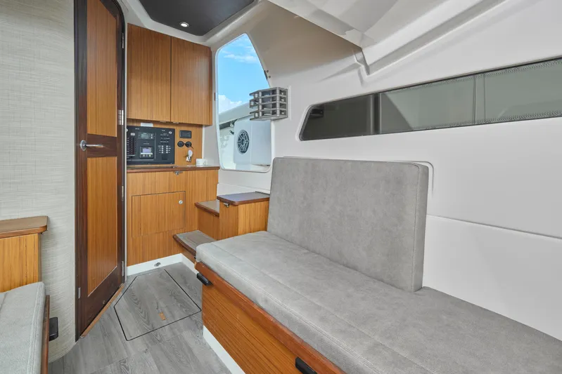 Tropical Moon Yacht Photos Pics 2022 Solace 41 CS cabin interior with wooden cabinetry and gray seating.
