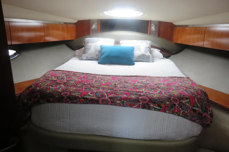 Swept Away Yacht Photos Pics Luxurious cabin interior of 2007 Cruisers Yachts 420 Express with vibrant bedding.