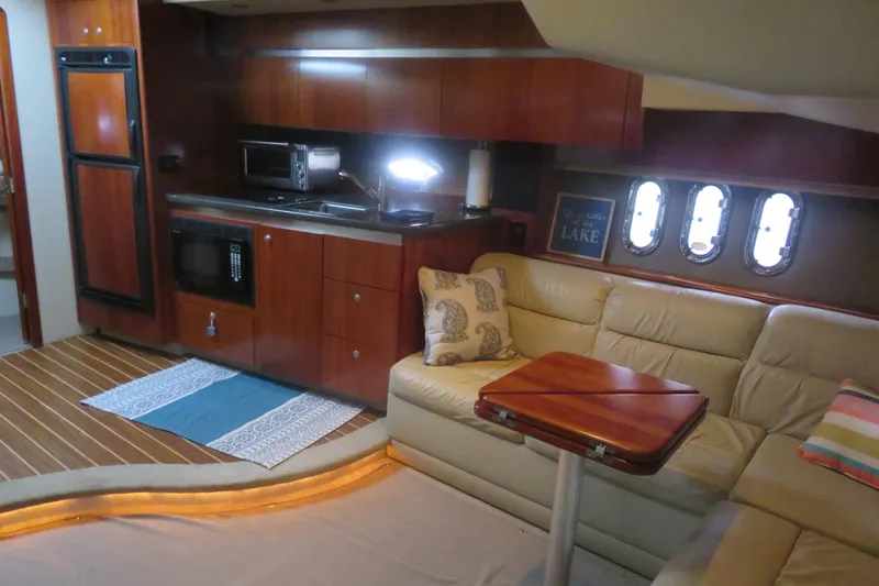 Swept Away Yacht Photos Pics Luxurious 2007 Cruisers Yachts 420 Express interior with kitchenette and cozy seating area.