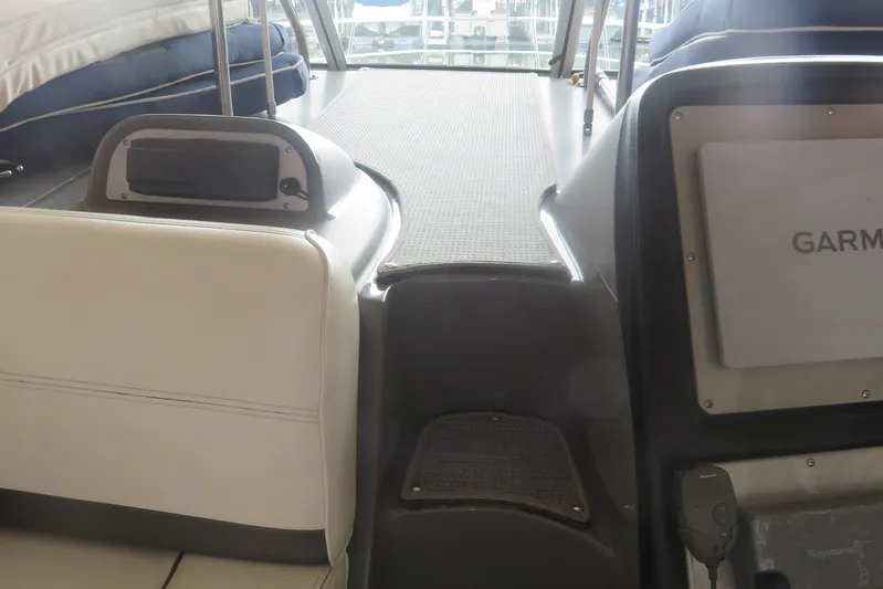 Swept Away Yacht Photos Pics 2007 Cruisers Yachts 420 Express interior with Garmin navigation system and seating area.